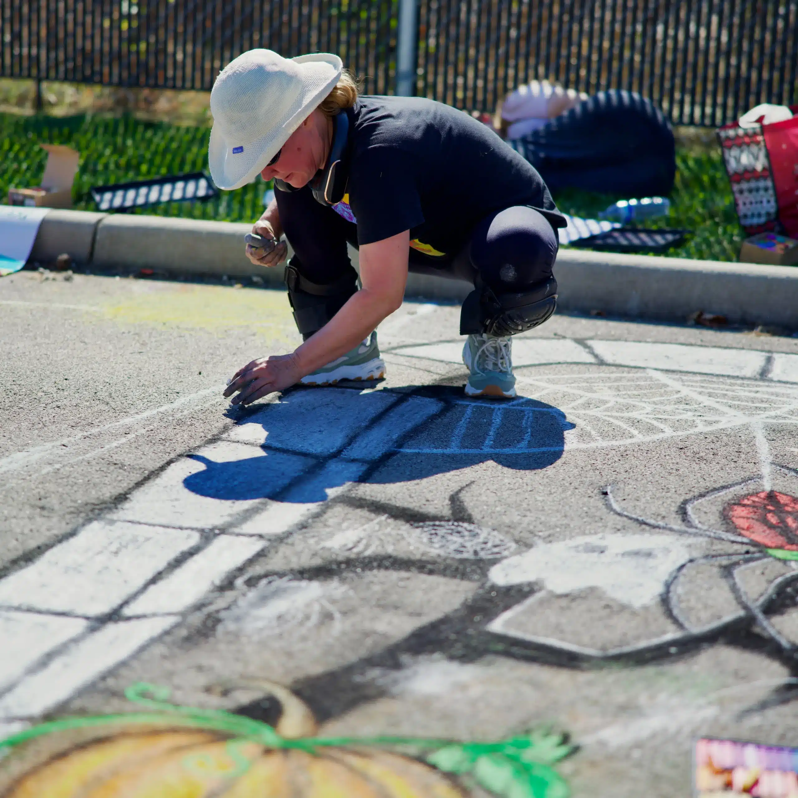 Artist creating colorful street mural